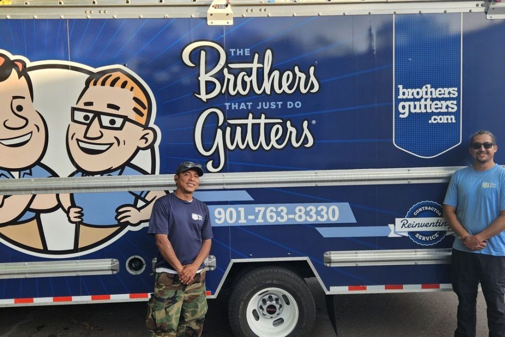 Two installers in front of the Central Mid-South box truck
