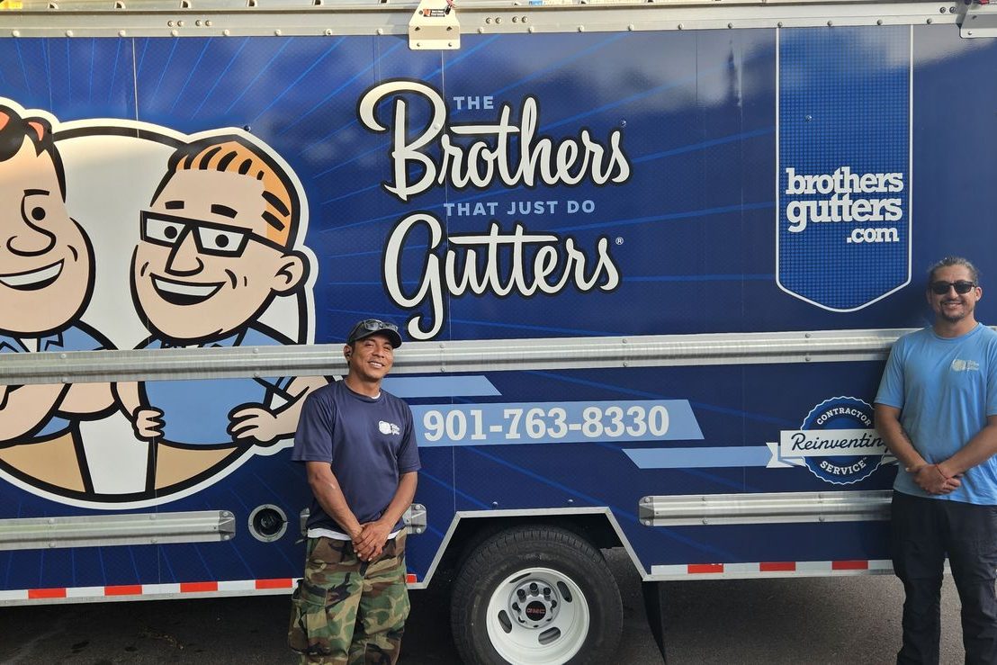 Two installers in front of the Central Mid-South box truck