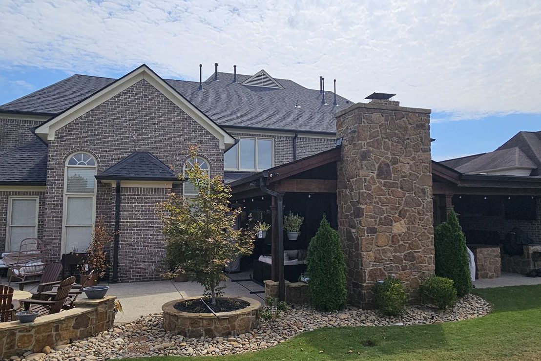 Back of a two-story brick home with a finished gutter line